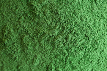Texture of green powder pigment as background, closeup