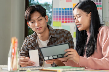 Creative design team brainstorming graphics for project development in modern workspace