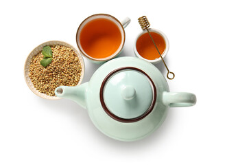 Cup and teapot of hot buckwheat tea with honey on white background