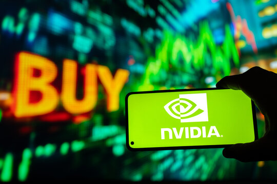 Nvidia logo on smartphone screen, green stock market chart spelling "buy" background. AI artificial intelligence concept growth bull or bullish wall street market, Puebla, Mexico, December 22, 2024