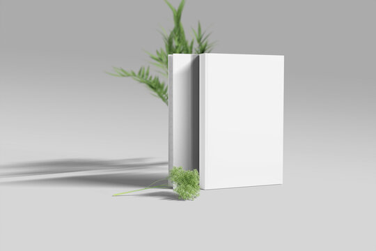 Blank standing hardcover book mockup with green palnt