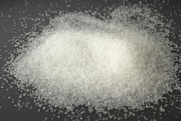 White sugar on a grey background