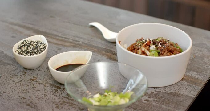 Delicious Asian noodle dish garnished with sesame seeds and green onions