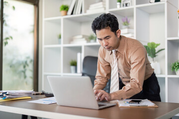 Focused business professional working on laptop in modern office environment productivity technology contemporary workspace