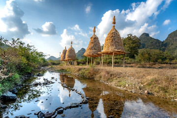 Fototapeta premium Rural Vietnam, new haystacks by the stream of ethnic minorities in Cao Bang, Vietnam. Peaceful image