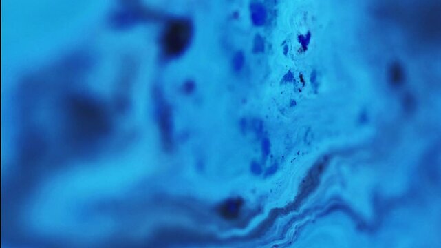 Blur ink. Acrylic liquid. Defocused blue color glowing fluid emulsion blend flow spreading motion decorative abstract art background.