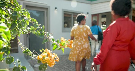 Arriving home with suitcase, African American women ready for family gathering