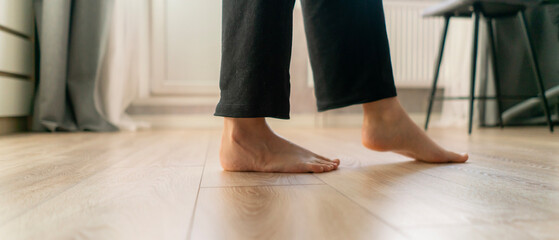 Barefoot walking on warm wooden flooring provides comfort and relaxation in a cozy interior space...
