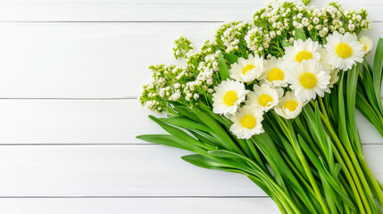 Obraz premium White daisies and greenery on wooden background