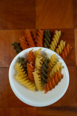 Pasta de tornillo cruda presentada sobre el plato blanco redondo