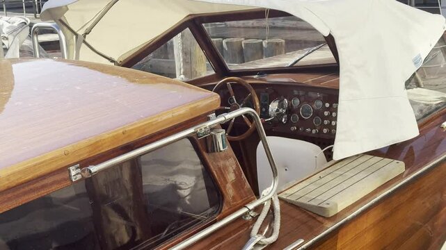 Interior of a classic wooden water taxi in Venice, featuring polished woodwork, vintage controls, and a cozy cabin design. A timeless symbol of Venetian transport. Check my portfolio for more Venice f