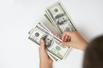money dollars in hands, counting cash on white table, top view	
