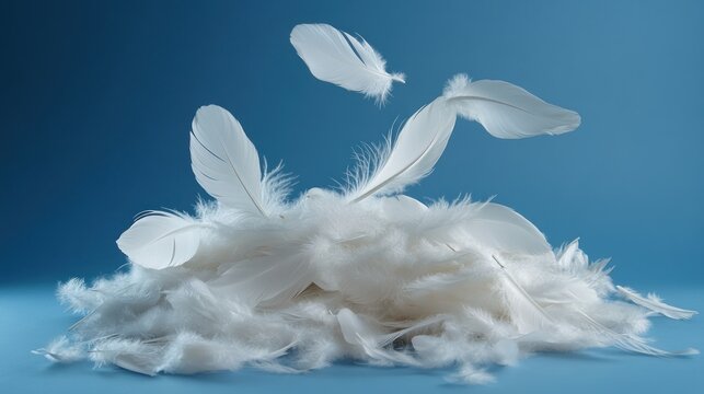 White feathers floating and piled on blue background.