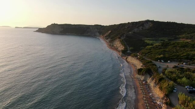 Aerial view of arillas beach, sea, and coastal town at sunset. Corfu ,Greece