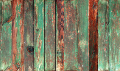 Texture of vintage wood boards with cracked paint of brown and green color. Horizontal retro background with old wooden planks of different colors