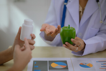 Nutritionist giving consultation to patient with healthy fruit and vegetable, Right nutrition and...