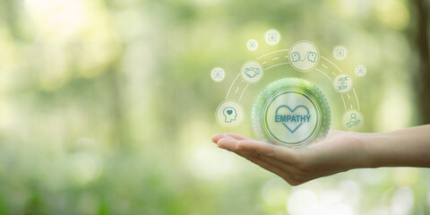 Empathy concept. Hand holding  the  empathy icons on natural background and copy space. The power...
