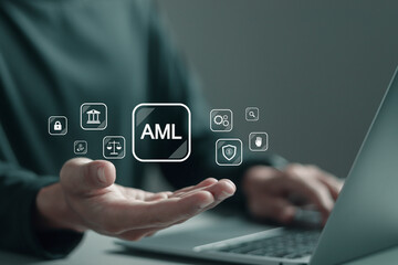 AML, Anti money laundering financial bank concept. Person using laptop with AML icons on virtual screen for anti money laundering regulations.