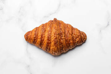 Croissant on white marble background