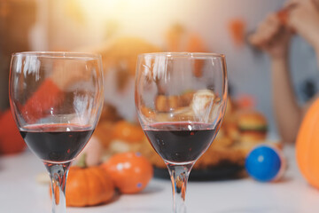 friendship, holiday and people concept - group of happy smiling friends in halloween costumes of vampire, devil, witch and cheetah at home party