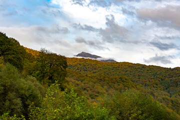 Cloudy evening at a picturesque mountain resort in autumn, Mountain peaks shrouded in clouds. Early...