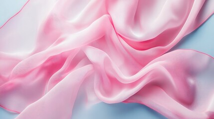 Obraz premium Delicate soft pink silk fabric draped elegantly on a serene pale blue background creating a soothing textile aesthetic