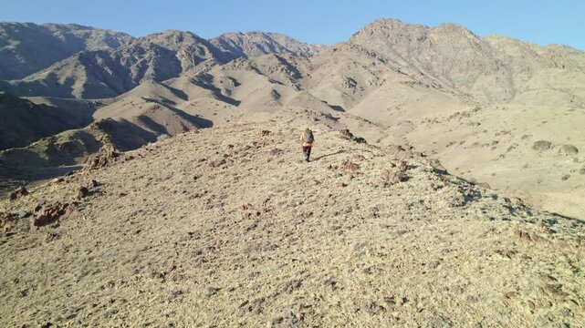 Hiker, trekking in the mountains with backpack, beautiful lendscape, panorama.
Person walking in the mountains. Hiking scenery in the mountains.
