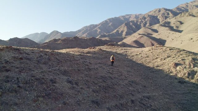 Hiker, trekking in the mountains with backpack, beautiful lendscape, panorama.
Person walking in the mountains. Hiking scenery in the mountains.