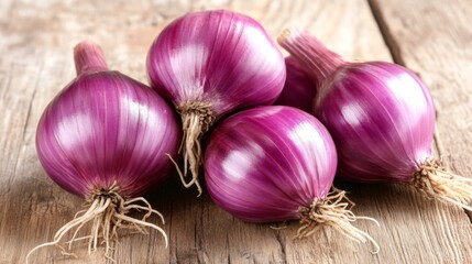A close-up shot of fresh shallots resting on a rustic wooden table, showcasing their vibrant purple skins and delicate roots against a soft natural light