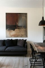 Stylish living room featuring abstract art, a cozy sofa, and a rustic dining table with chairs, showcasing modern minimalist design.