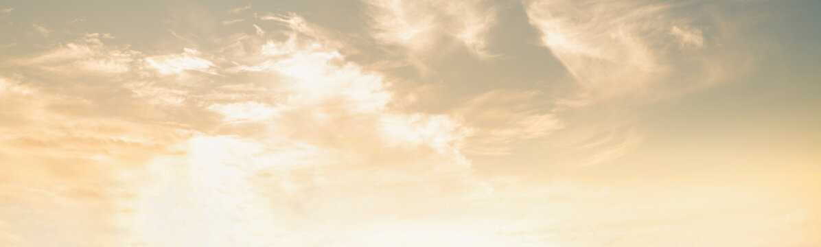 Orange panorama of soft clouds at sunrise. Cloudy fog in the sky during humid weather and hot season. Sky background 