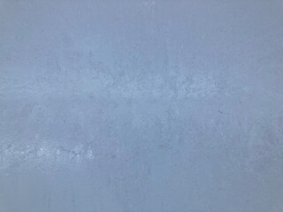 Fototapeta premium Close-up of an ice wall with small cracks. Outdoors in winter. It's frozen. Light is shining through it.
