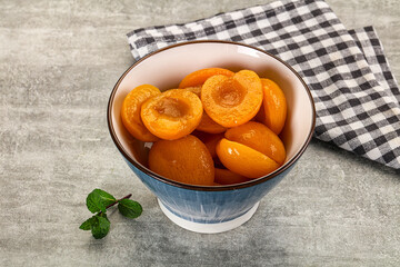 Sweet canned apricots with syrope