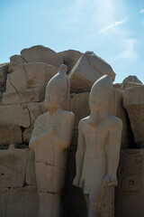 Two kings near Stone ruins from the ruined temple in Luxor