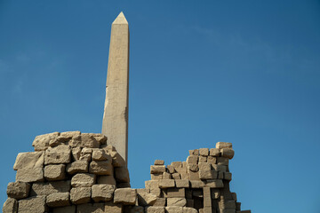 Obelisk in the ancient city of Karnak among the ruins