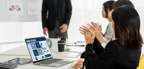 Human resources management software on computer screen helping human resources employee to manage recruitment, payroll, staff searching and KPI evaluation snugly