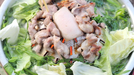 Grilled Meat Dish with Fresh Greens.Close-Up of Grilled Pork on a Plate.