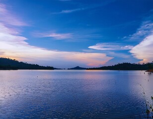 A breathtaking scenic view of a calm lake, stretching out under a vast sky.