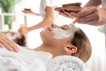 Serene ambiance of spa salon, couple indulges in rejuvenating with luxurious face cream massage with modern daylight. Facial skin treatment and beauty care concept. Quiescent