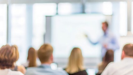 Team Workshop Presentation – A blurred image of a team engaged in a workshop session with a speaker presenting.

