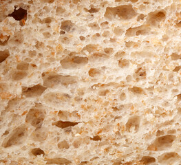 The bread has a rough texture with holes in it