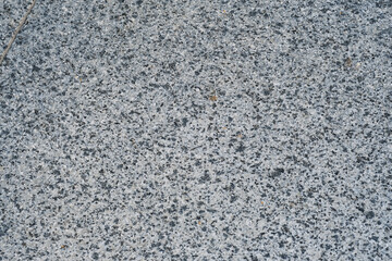 Close-up of a textured granite surface showcasing rich speckles and natural patterns in daylight