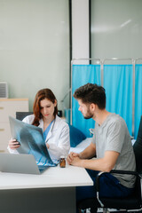 Fototapeta premium Portrait of female doctor explaining diagnosis to her patient. Doctor Meeting With Patient In Exam Room