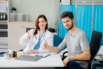 Fototapeta premium Portrait of female doctor explaining diagnosis to her patient. Doctor Meeting With Patient In Exam Room