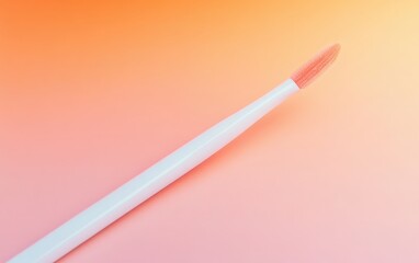 A close-up of a lip gloss applicator with a sleek, slender design, resting on a minimalistic, light-colored background, highlighting the product's shine and precision