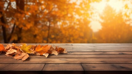 Obraz premium Autumn Table with Orange Leaves on Wooden Plank Against a Beautiful Sunlit Background of Fall Foliage and Warm Colors