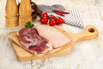 Raw duck breast over board