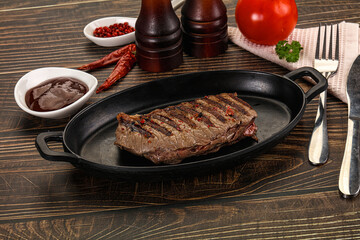 Grilled beef striploin steak with sauce