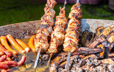 Cooking traditional appetizing hot shish kebab or shashlik on skewers. Street food and outdoor cooking
