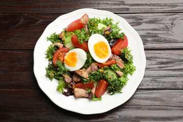 Delicious fresh tuna salad on wooden table, top view